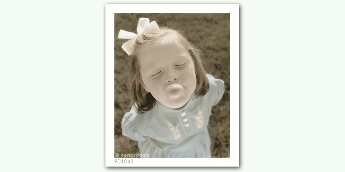 photograph of girl blowing bubble