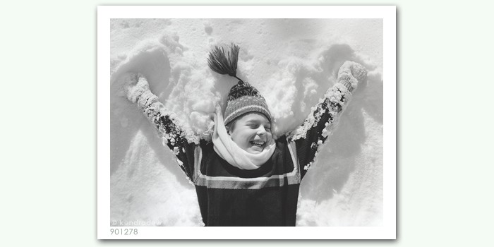 photograph of boy in snow