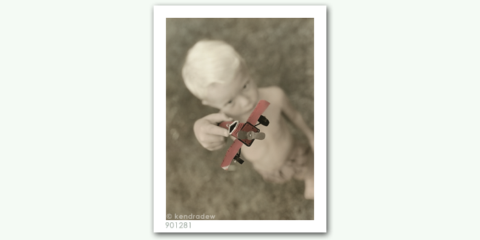 photograph of boy with plane