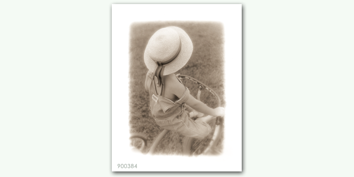 photograph of boy on tricycle