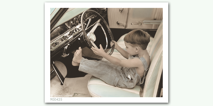 photograph of boy in car