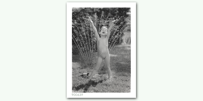 photograph of girl and sprinkler