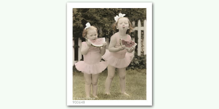 photograph of girls eating melon