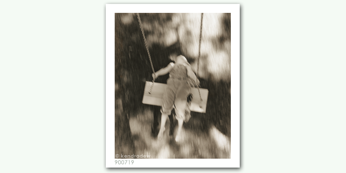 photograph of girl on swing