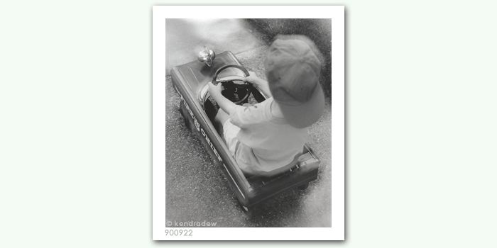 photograph of boy riding truck