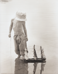 photograph of boy with boat