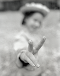 photograph of girl with smiley hand