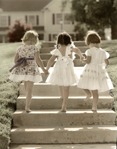 photograph of girls in dresses ascending stairs